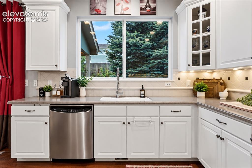 Image 12 of 50: Natural light over the sink and thoughtfully arranged counter space make th