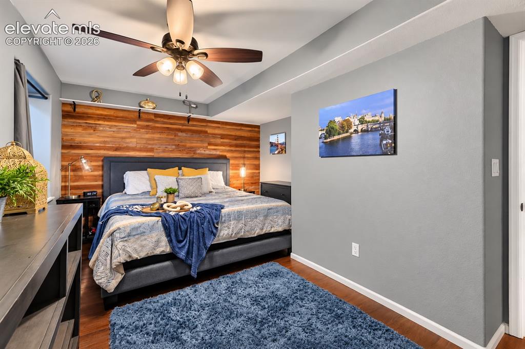Image 20 of 50: A bright secondary bedroom offers comfortable space for family, guests or a