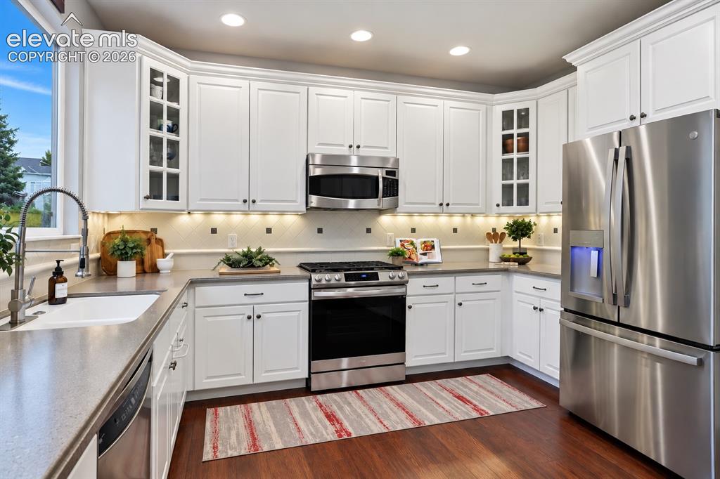 Image 25 of 50: Abundant cabinetry, expansive counters and stainless appliances combine sty