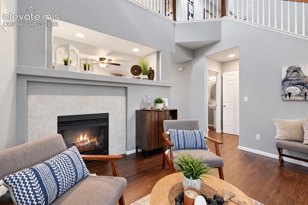 Image 30 of 50: A cozy fireplace anchors this inviting conversation area without sacrificin