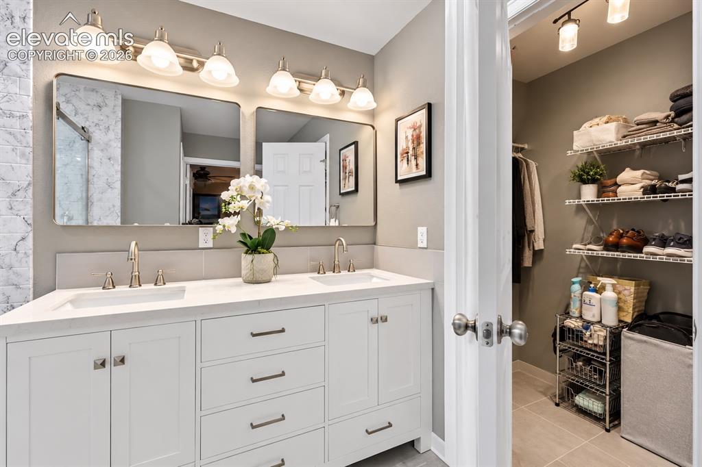 Image 31 of 50: Dual sinks and generous vanity space make busy mornings easier while mainta