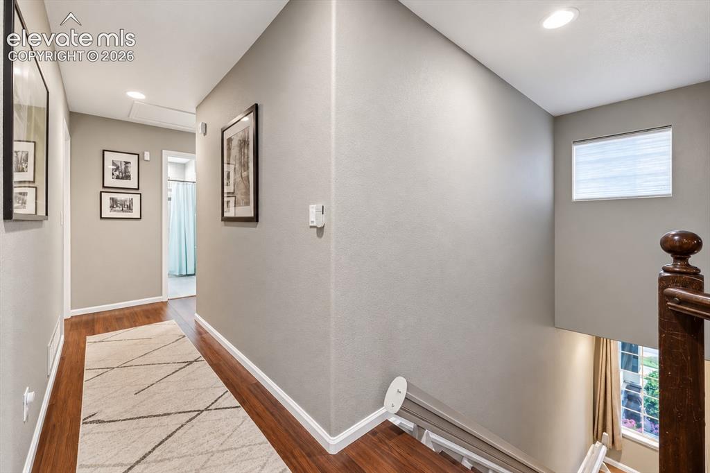 Image 33 of 50: The upper hallway overlooks the main level, emphasizing the home