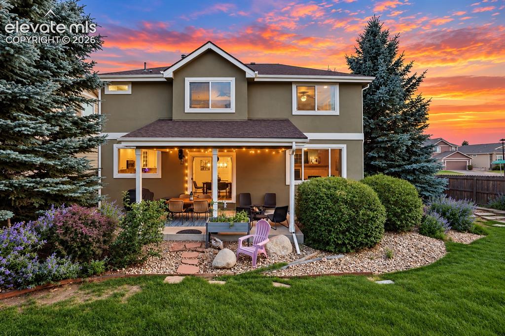 Image 35 of 50: Mature landscaping and usable outdoor space create an inviting setting just