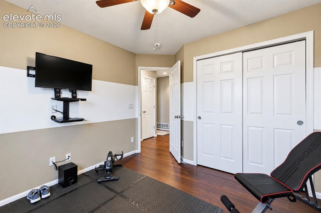 Image 37 of 50: Flexible third bedroom currently arranged as a home gym, offering plenty of