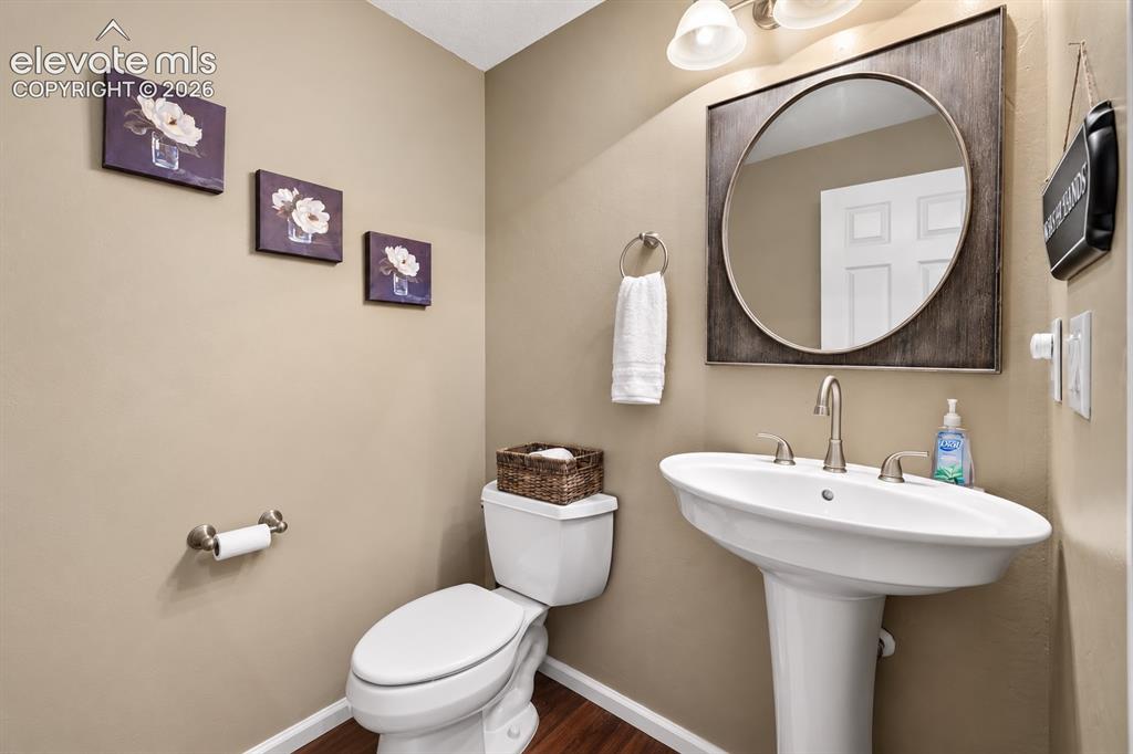 Image 38 of 50: A convenient main-level powder bath is thoughtfully positioned for family a