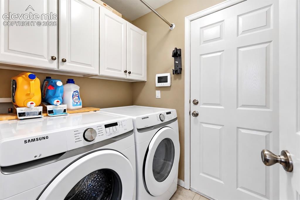 Image 39 of 50: Dedicated laundry space and upper cabinetry add practical storage to the ho
