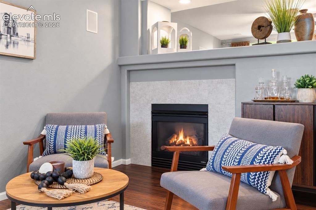 Image 6 of 50: Gather around the fireplace in a comfortable living space that feels warm a