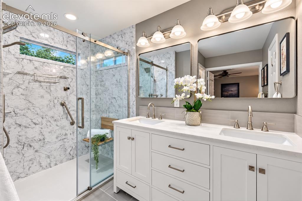 Image 9 of 50: The beautifully updated primary bath pairs clean contemporary finishes with