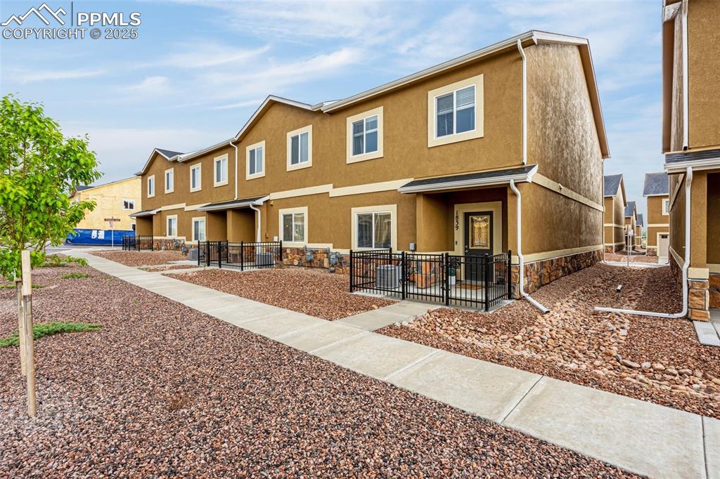 Caption: Rear view of house featuring stucco siding