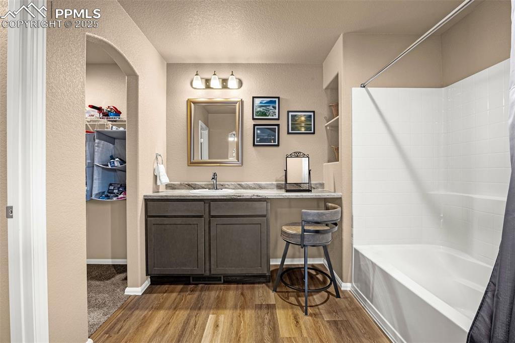 Image 17 of 34: Full bathroom featuring shower / washtub combination, wood finished floors,