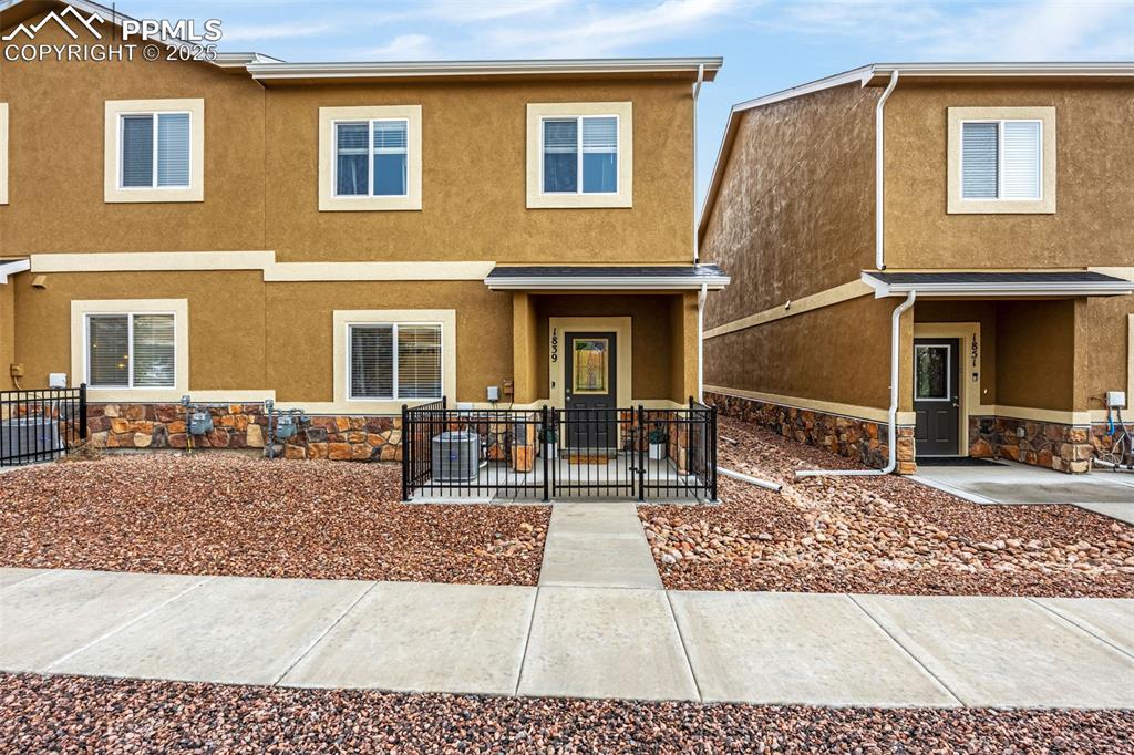 Image 2 of 34: Multi unit property with stucco siding and stone siding
