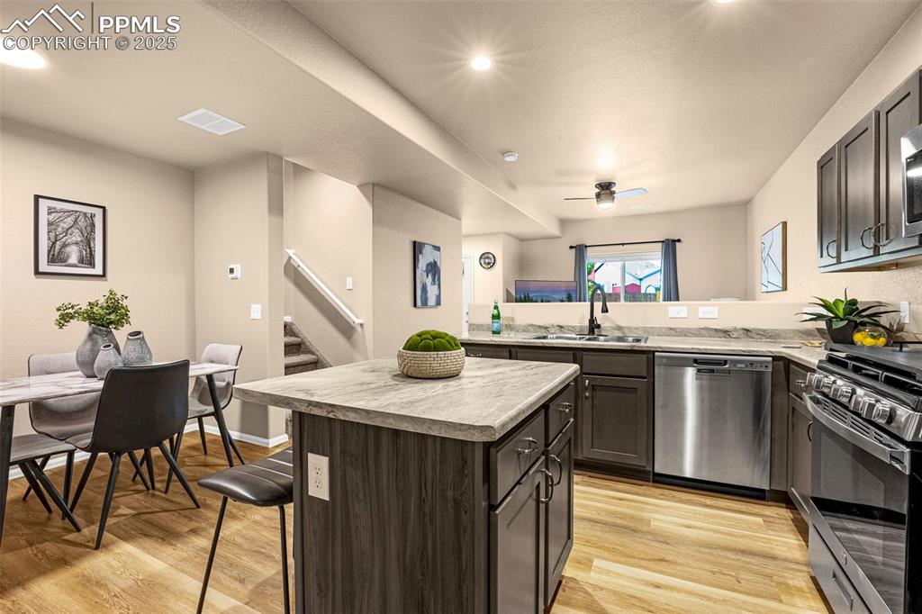 Image 5 of 34: Kitchen featuring stainless steel appliances, a sink, light countertops, li
