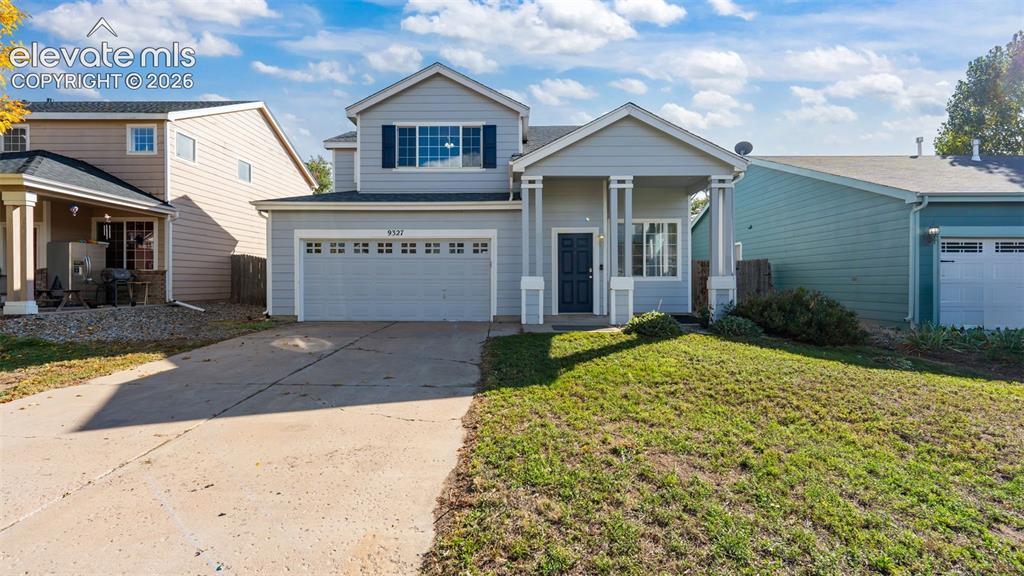 Image 1 of 26: Two-story residence featuring a covered front porch, attached two-car garag