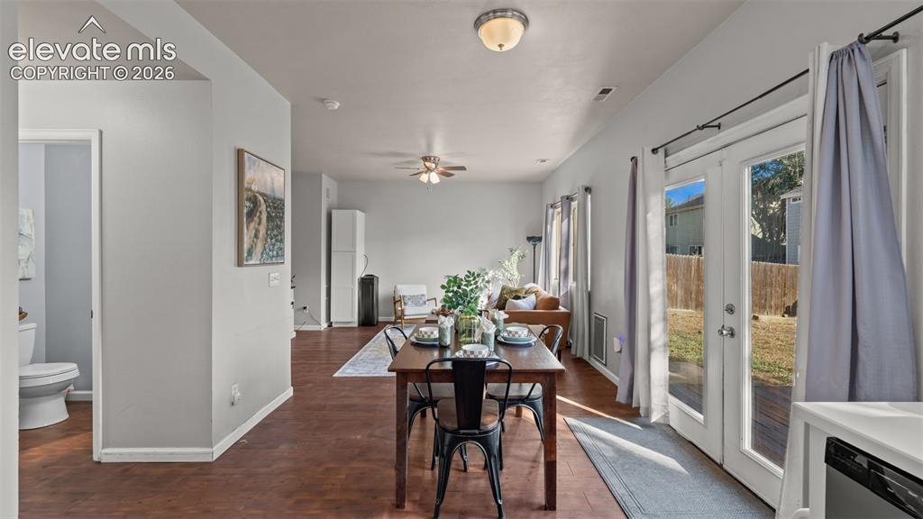 Image 12 of 26: Open-concept living area with wood-finish flooring, recessed lighting, and
