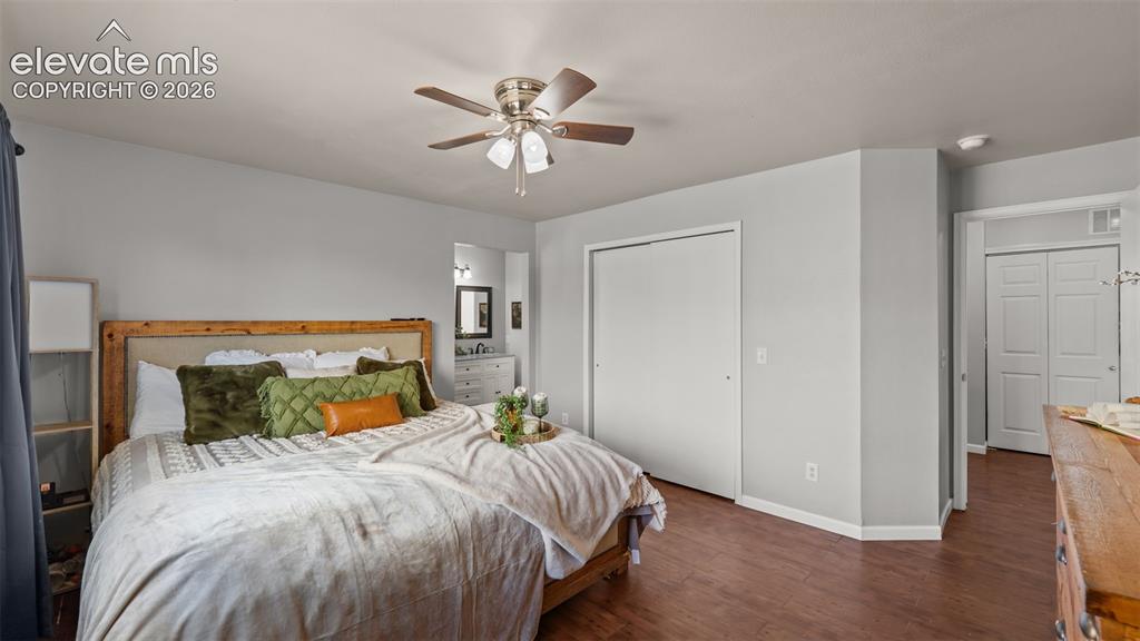 Image 18 of 26: Wood-finish flooring, ceiling fan with integrated lighting, and multiple cl