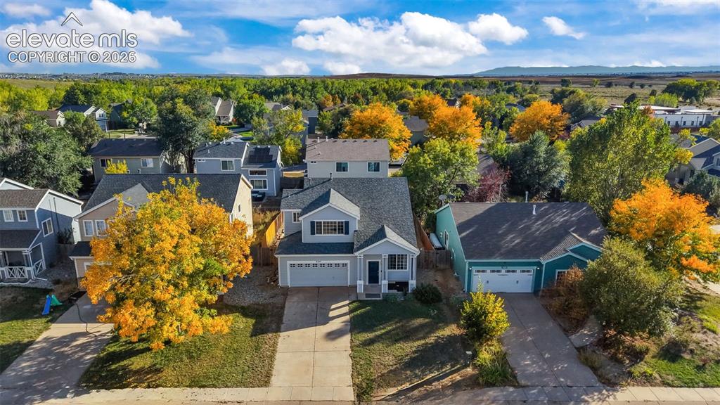 Image 23 of 26: Two-story residence with a two-car garage, front-facing dormer, and a cover