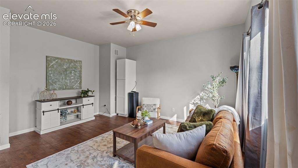 Image 9 of 26: Hardwood-finish flooring, light gray wall tones, ceiling fan, and window wi