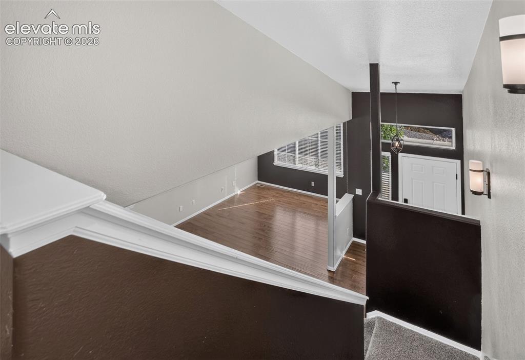 Image 16 of 46: Hardwood-style flooring, white paneled door, horizontal window, and recesse