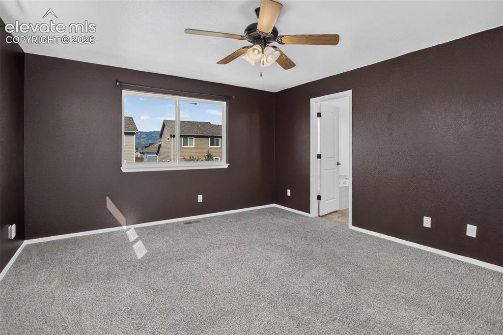 Image 18 of 46: Neutral carpet flooring, a ceiling fan with integrated lighting, and a whit
