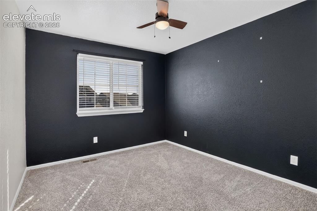Image 24 of 46: Window with horizontal blinds, overhead ceiling fan with light, and carpete