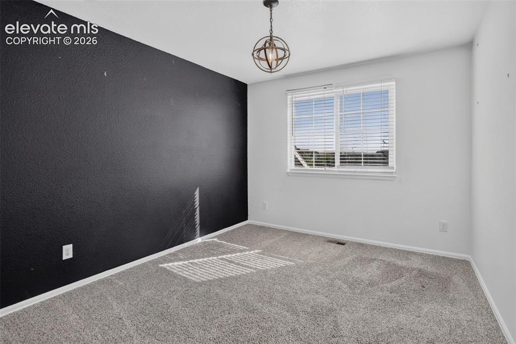 Image 25 of 46: Carpet flooring, single window with blinds, ceiling-mounted light fixture,