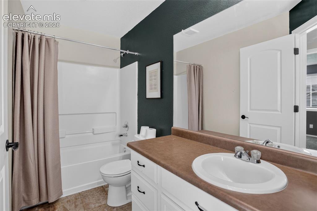 Image 27 of 46: White vanity with a laminate countertop and integrated sink