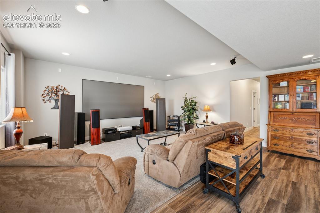 Image 28 of 40: Family room featuring recessed lighting and lots of natural light; the perf