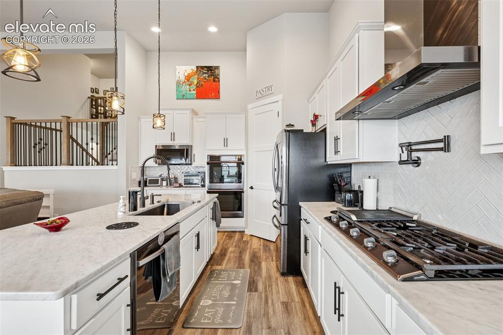 Image 9 of 40: Kitchen is open, conveniently set-up and everyone loves a gas stove with po