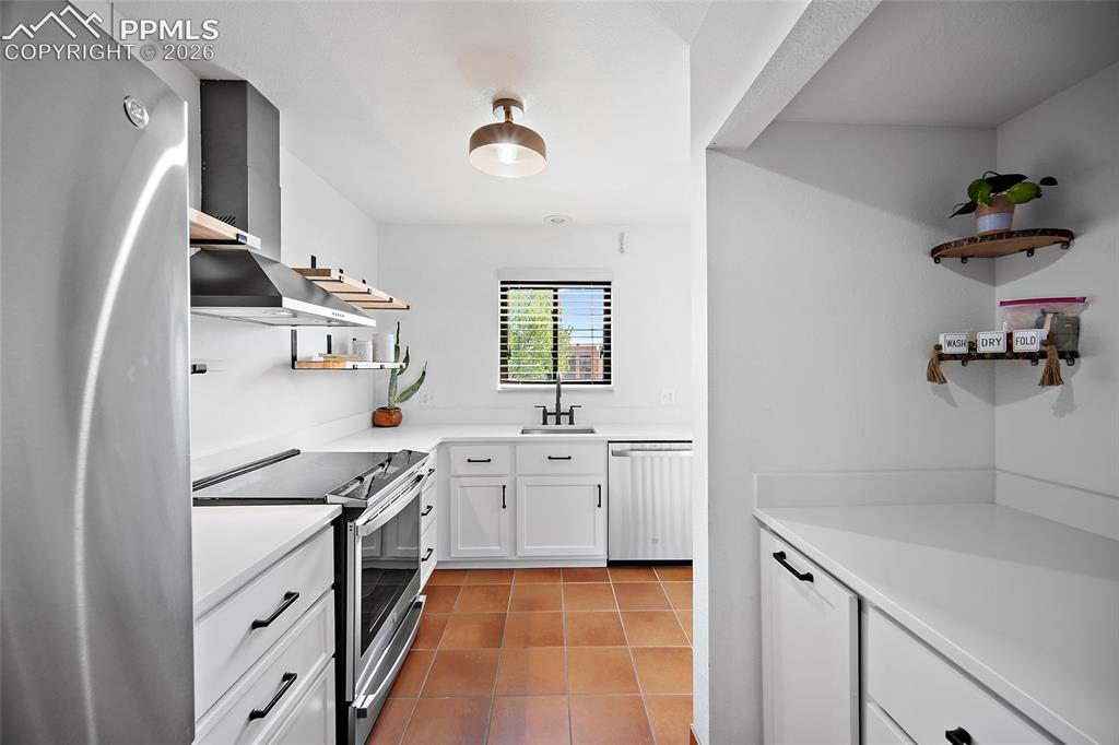 Image 13 of 41: Updated kitchen with quartz countertops.
