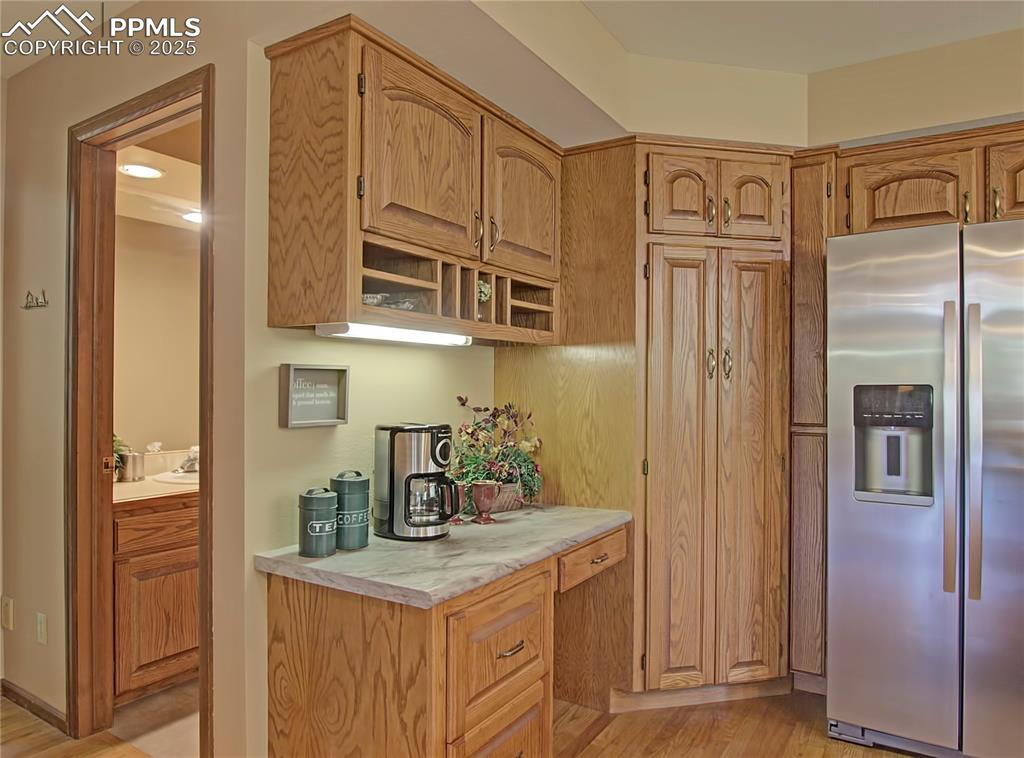 Image 13 of 40: Desk provides great space for a coffee bar.