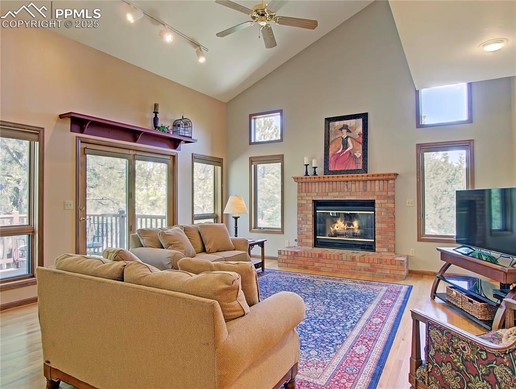 Image 16 of 40: Great room has large beautiful windows with views of the Pondersoa Pine tre