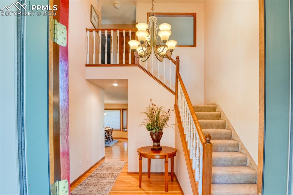 Image 2 of 40: Entry welcomes one with hardwood floors that extend into the kitchen and gr