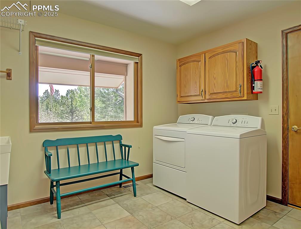 Image 20 of 40: Main level laundry room has window and deep sink. 
