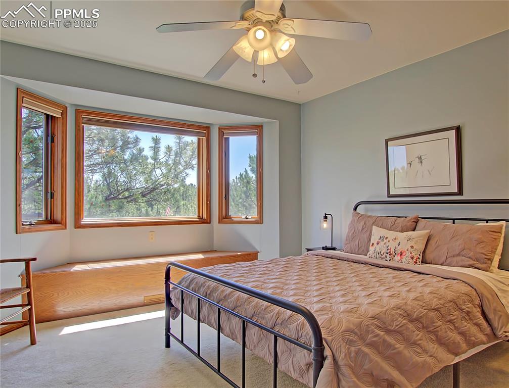 Image 31 of 40: Upstairs bedroom has bay window with window seat that opens for storage and
