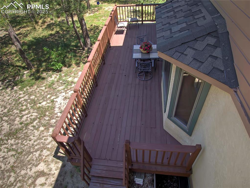 Image 32 of 40: View of lower deck from the deck off the master bedroom