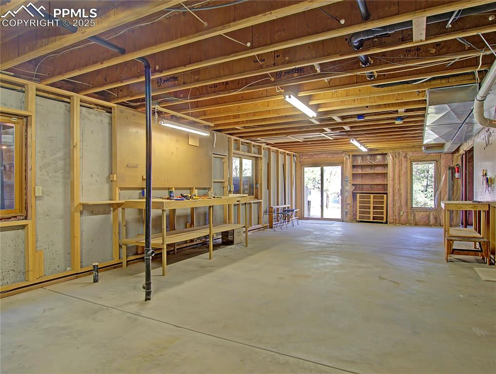 Image 33 of 40: Walkout unfinished basement makes a perfect workshop or storage for all you