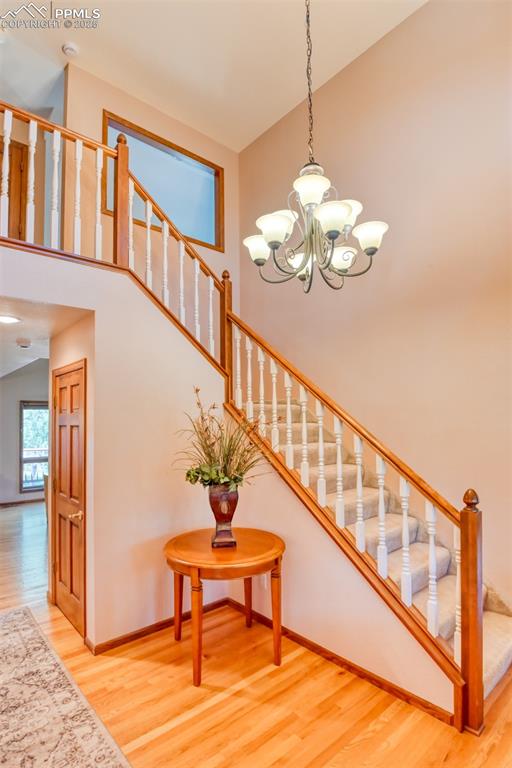 Image 4 of 40: Main level entry has a vaulted ceiling and hardwood floors. 