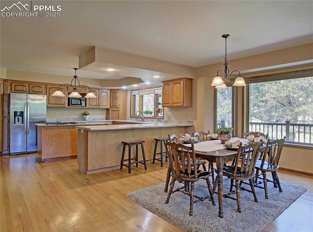 Image 8 of 40: Kitchen is open to the large eating area for family and friends to gather.
