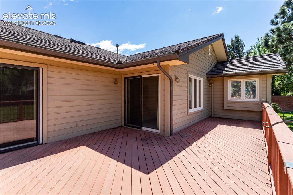 Image 29 of 40: Expansive wood-finish deck with a visible railing, providing outdoor access