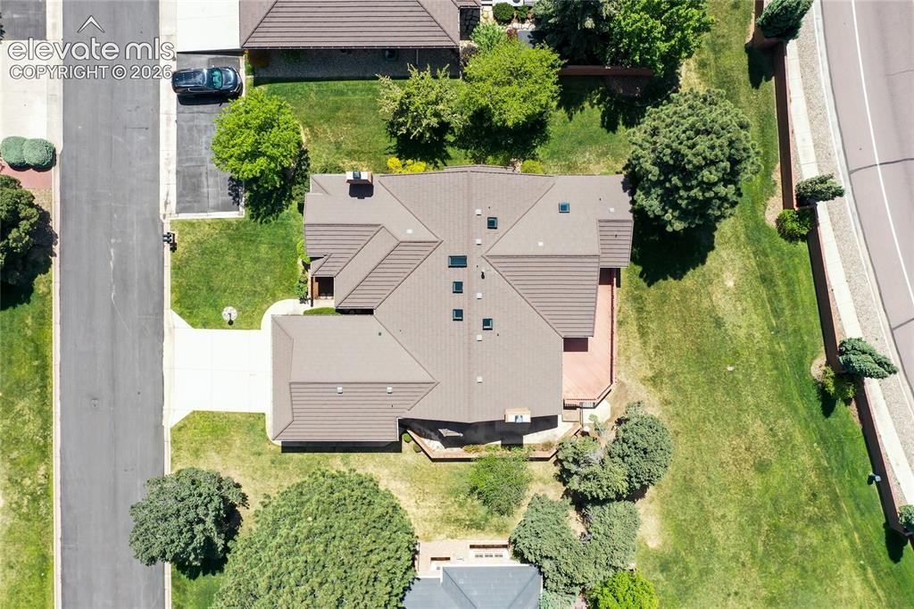 Image 34 of 40: Property featuring a multi-gabled roof, multiple skylights, and an expansiv