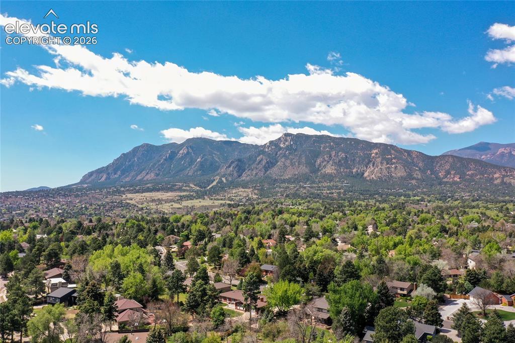 Image 36 of 40: Expansive mountain backdrop with a wide residential area featuring numerous