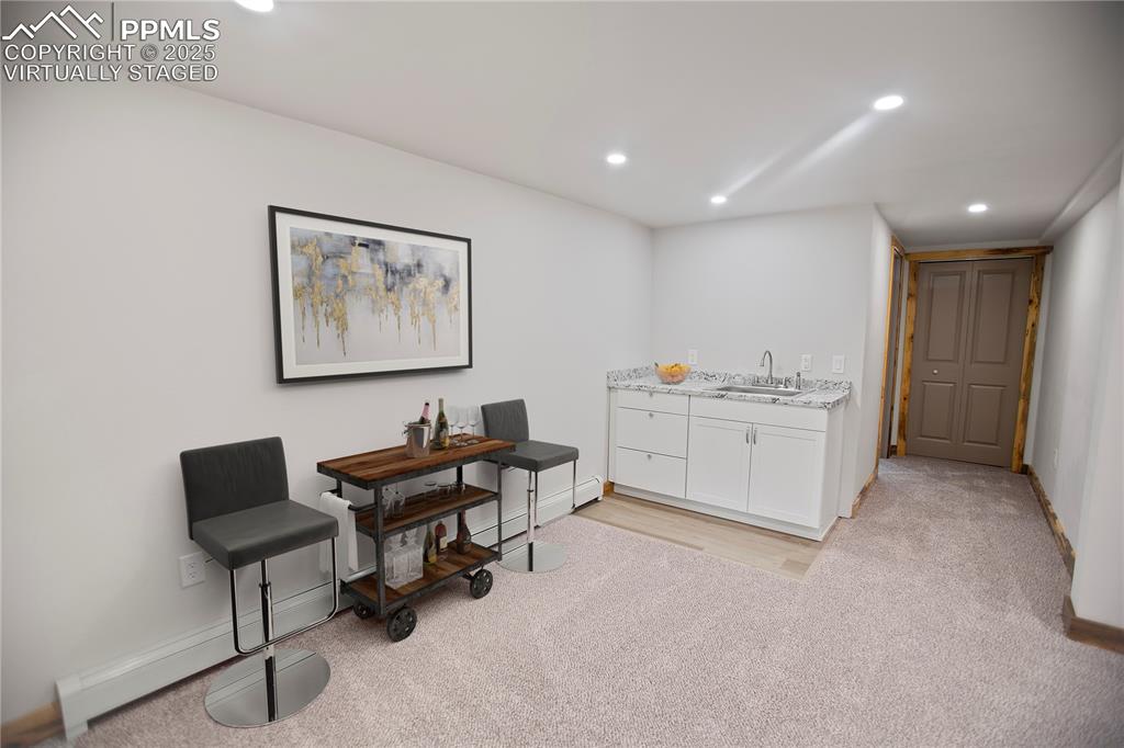 Image 18 of 49: Lower level family with wet bar  - Virtually Staged