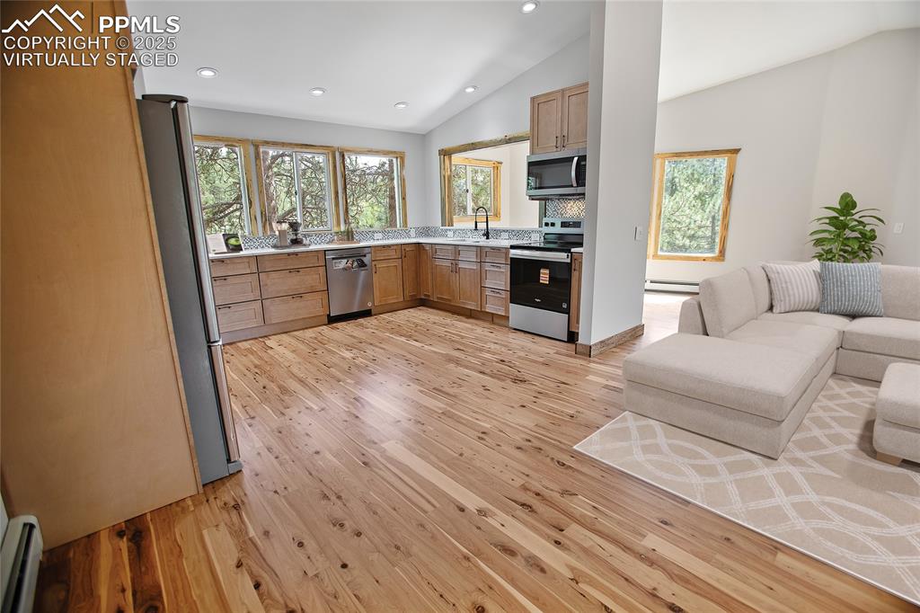 Image 7 of 49: Living room and kitchen  - Virtually Staged