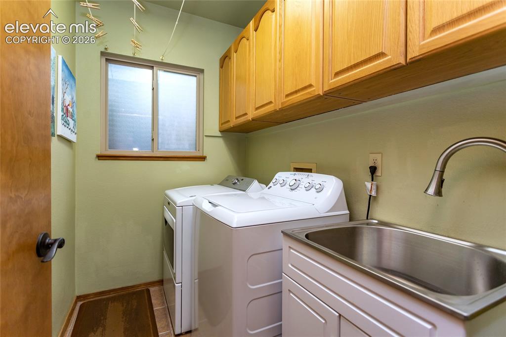 Image 17 of 50: Main Level Laundry Room features Clothes Washer and electric Dryer, handy S