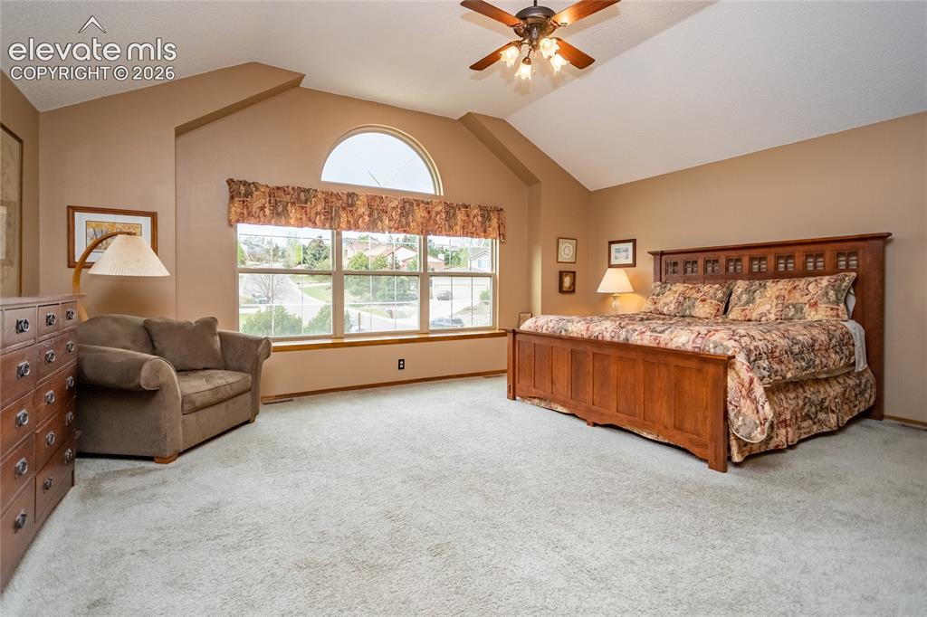 Image 18 of 50: Huge Primary Bedroom w/ Vaulted Ceilings and plenty of Sitting/ Dressing Sp