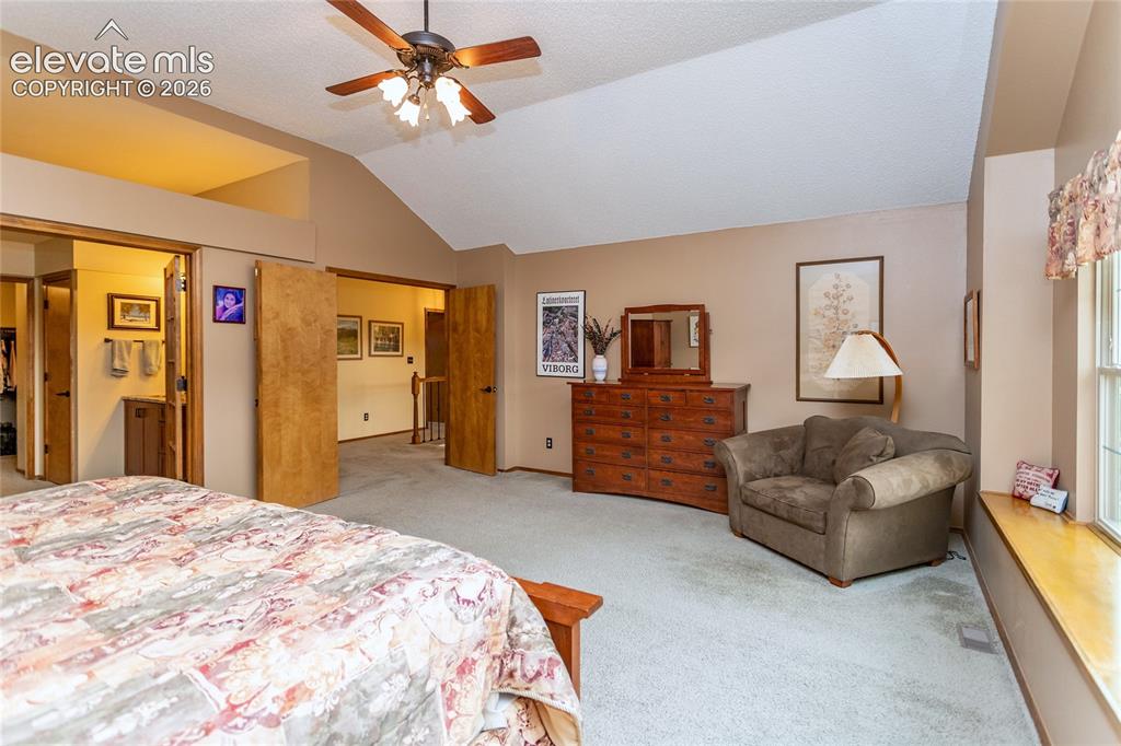 Image 19 of 50: Primary Bedroom with French Doors and Private Bathroom Suite