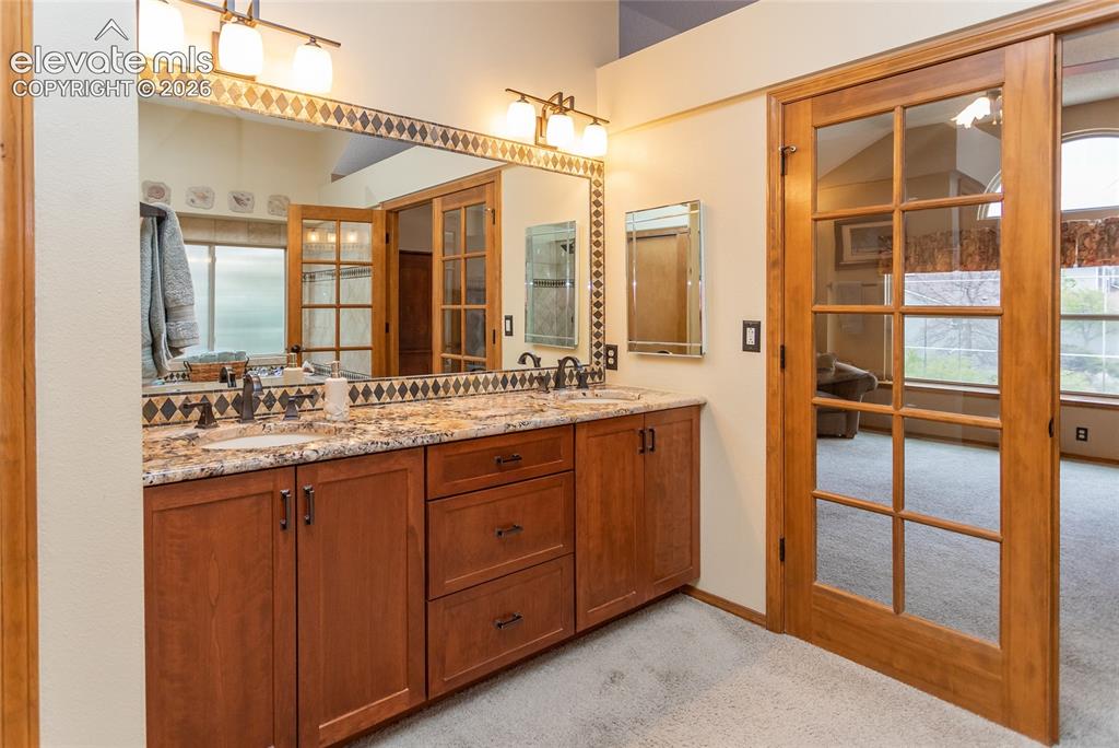 Image 23 of 50: Primary Bathroom Double Vanity and Granite Countertop