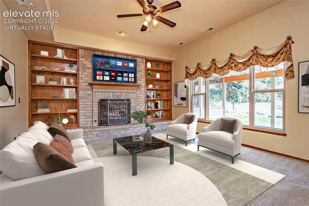 Image 3 of 50: Virtually Staged: Main Level Family Room w/ Gas Fireplace and Bookcase Buil