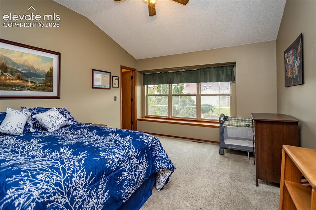 Image 30 of 50: Fourth Bedroom on Upper Level (North facing) has Vaulted Ceiling and Large