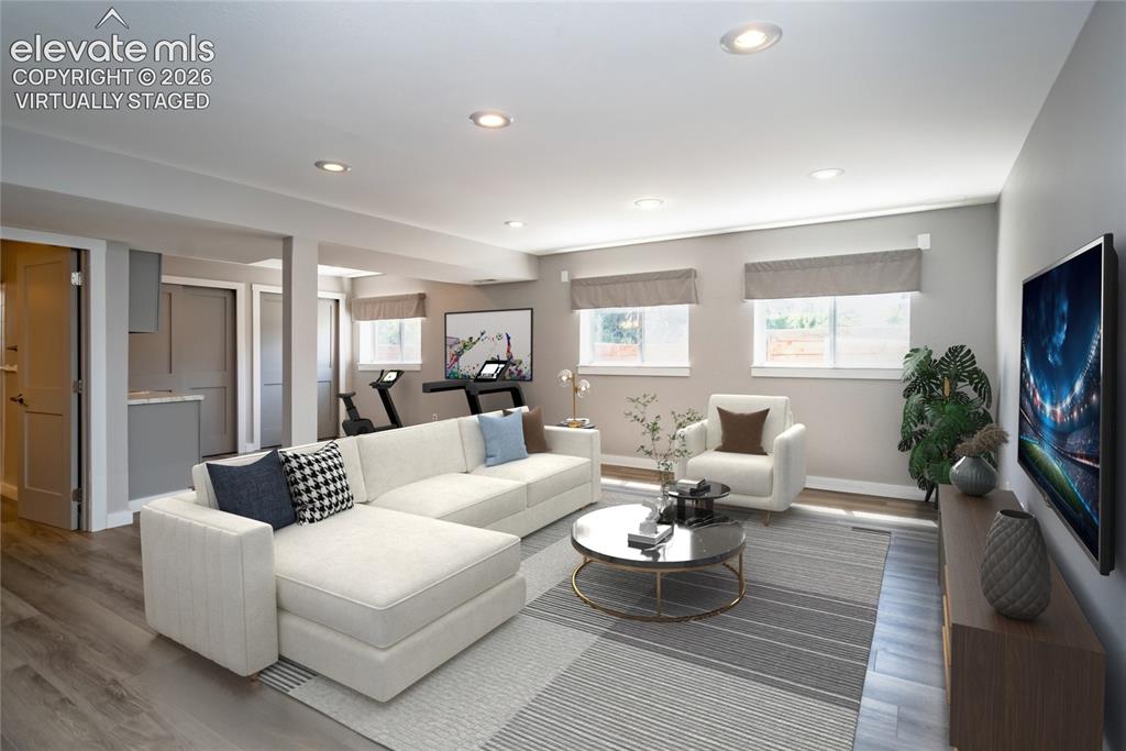 Image 32 of 50: Virtually Staged: Huge Basement Recreation Room has laminate Flooring and G